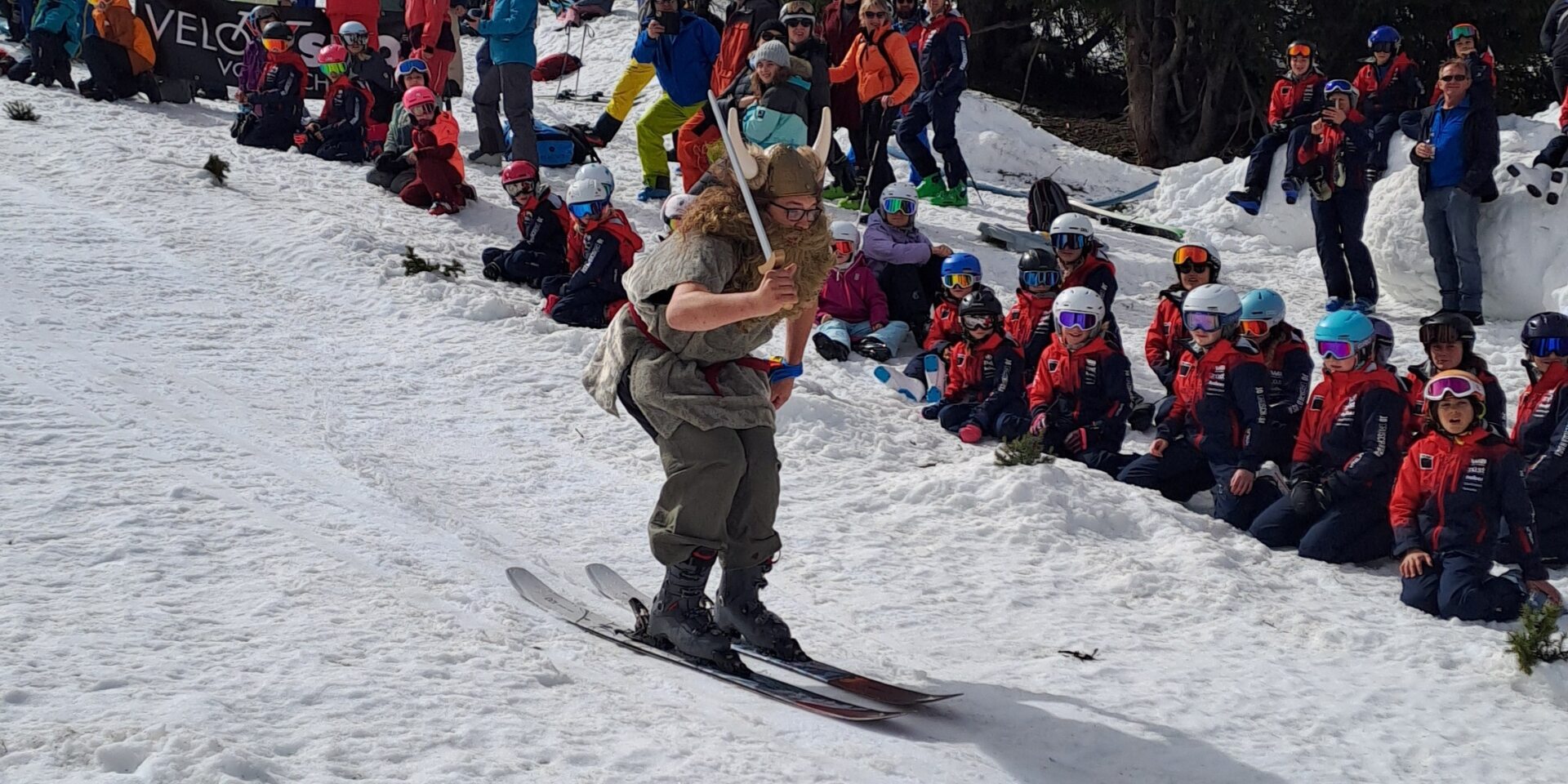 Verkleideter Skifahrer holt Anlauf für die Wasserüberquerung am Waterslide