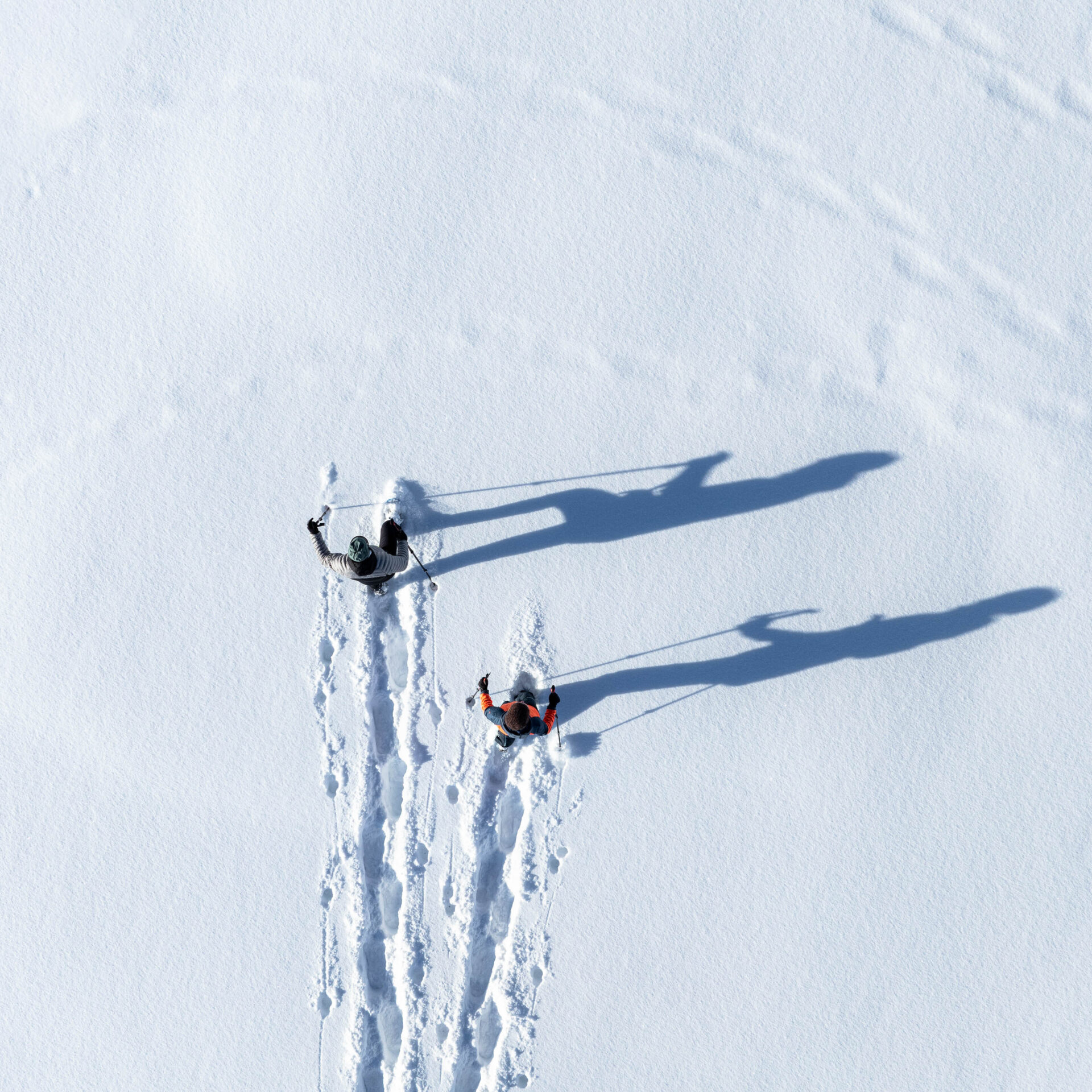 Zwei Schneeschuhwanderer von der Vogelperspektive im Tiefschnee